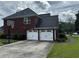 Spacious two-car garage with ample driveway space and convenient basketball hoop for Gathering fun at 1498 Park Knoll Trl, Lawrenceville, GA 30043