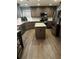 Well-lit kitchen featuring an island, stainless steel appliances, granite counters, and wood floors at 1498 Park Knoll Trl, Lawrenceville, GA 30043