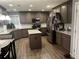 Well-appointed kitchen with stainless steel appliances, granite countertops, island, and wood flooring at 1498 Park Knoll Trl, Lawrenceville, GA 30043