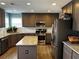 Spacious kitchen featuring stainless steel appliances, granite countertops, and wood cabinets at 1498 Park Knoll Trl, Lawrenceville, GA 30043