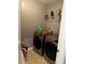 Laundry room featuring modern washer and dryer units with overhead shelving at 1498 Park Knoll Trl, Lawrenceville, GA 30043