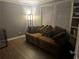 Inviting living room with hardwood floors, a comfortable brown couch, and bright natural light at 1498 Park Knoll Trl, Lawrenceville, GA 30043