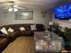 Comfortable living room with a ceiling fan, mounted TV, and ample seating at 1498 Park Knoll Trl, Lawrenceville, GA 30043