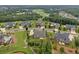 Aerial view of homes showcasing the neighborhood's layout, mature trees, and the golf course in the background at 406 Horizon Trl, Canton, GA 30114