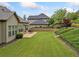 Beautiful backyard with patio area, lush lawn, mature trees, and privacy at 406 Horizon Trl, Canton, GA 30114