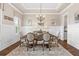 Formal dining room with tray ceiling, wainscoting, elegant chandelier, and hardwood floors at 406 Horizon Trl, Canton, GA 30114