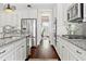 Bright, modern kitchen featuring stainless steel appliances, granite counters, and dark hardwood flooring at 406 Horizon Trl, Canton, GA 30114