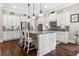 Spacious kitchen with white cabinets, granite countertops, stainless appliances, and large central island at 406 Horizon Trl, Canton, GA 30114