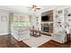 Inviting living room with stone fireplace, built-in shelving, comfortable seating, and natural light at 406 Horizon Trl, Canton, GA 30114