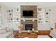 Cozy living room features a stone fireplace, built-in shelves, and comfortable seating at 406 Horizon Trl, Canton, GA 30114