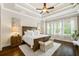 Bright main bedroom with tray ceilings, a ceiling fan, and plenty of natural light at 406 Horizon Trl, Canton, GA 30114