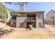 Exterior view of a two-story house with a balcony and a backyard at 4595 Carriage Walk Ln, Cumming, GA 30040