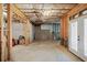 Unfinished basement with concrete walls and walkout door to backyard at 4595 Carriage Walk Ln, Cumming, GA 30040