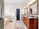 Well-lit bathroom showcasing a double vanity, soaking tub, and elegant finishes at 4595 Carriage Walk Ln, Cumming, GA 30040