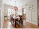 Formal dining room with hardwood floors, wainscoting and stylish lighting fixture for elegant dinners at 4595 Carriage Walk Ln, Cumming, GA 30040