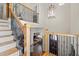 Grand foyer features a staircase, iron railings, and abundant natural light at 4595 Carriage Walk Ln, Cumming, GA 30040