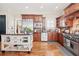 Functional kitchen with wooden cabinets, stainless appliances and movable island at 4595 Carriage Walk Ln, Cumming, GA 30040