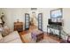 Inviting living room featuring hardwood floors and a view of the staircase through the glass paned french doors at 4595 Carriage Walk Ln, Cumming, GA 30040