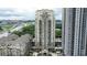 An impressive aerial view showcasing the condo high-rise against a cityscape backdrop and highway at 795 Hammond Dr # 503, Sandy Springs, GA 30328
