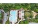 An aerial view shows a sparkling pool, manicured lawns, and a play area surrounded by lush greenery at 795 Hammond Dr # 503, Sandy Springs, GA 30328