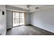 Bright bedroom featuring wood floors, ceiling fan, and balcony access at 795 Hammond Dr # 503, Sandy Springs, GA 30328