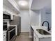 A modern kitchen with stainless steel appliances, white cabinets, and sleek countertops at 795 Hammond Dr # 503, Sandy Springs, GA 30328