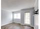 Bright living room with neutral walls, hardwood floors, and large windows leading to a private balcony at 795 Hammond Dr # 503, Sandy Springs, GA 30328