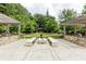 Outdoor kitchen and fire pit seating area with built-in grills for community use at 795 Hammond Dr # 503, Sandy Springs, GA 30328