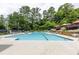 Community pool with lounge chairs and umbrellas at 795 Hammond Dr # 503, Sandy Springs, GA 30328