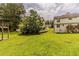 Expansive backyard featuring a grassy lawn between two homes, surrounded by mature trees at 1006 Eagle Vw, Lawrenceville, GA 30044