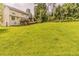 Expansive backyard with lush green grass and mature trees, perfect for outdoor activities and relaxation at 1006 Eagle Vw, Lawrenceville, GA 30044