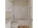 Bathroom featuring a shower-tub combo, cabinet storage, and toilet, providing functionality and convenience at 1006 Eagle Vw, Lawrenceville, GA 30044