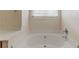 Bathroom featuring a large bathtub, vanity, and modern fixtures at 1006 Eagle Vw, Lawrenceville, GA 30044