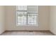 Cozy bedroom with neutral walls, carpeting, and a window overlooking the neighborhood at 1006 Eagle Vw, Lawrenceville, GA 30044