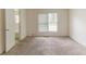 Spacious bedroom with neutral carpet and a view into the bathroom at 1006 Eagle Vw, Lawrenceville, GA 30044