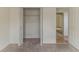 Closet with white door and wire shelving, adjacent to carpeted and tiled rooms at 1006 Eagle Vw, Lawrenceville, GA 30044