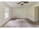 Open living room with a ceiling fan and carpet flooring offering a bright and inviting space at 1006 Eagle Vw, Lawrenceville, GA 30044
