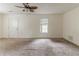 Well-lit living room with a ceiling fan and carpet flooring, providing ample space and comfort at 1006 Eagle Vw, Lawrenceville, GA 30044