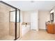 Bright bathroom with a tub-shower combo, glass door shower and granite countertop vanity at 2458 Brook Park Trl, Snellville, GA 30078