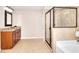Spacious bathroom featuring a glass-enclosed shower and granite countertop vanity at 2458 Brook Park Trl, Snellville, GA 30078