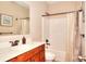 Bathroom featuring a vanity with wood cabinets and a shower/tub combo with a curtain at 2458 Brook Park Trl, Snellville, GA 30078