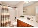 Bright bathroom featuring a shower-tub combo and a sink vanity at 2458 Brook Park Trl, Snellville, GA 30078