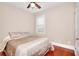 Comfortable bedroom with hardwood floors and a neutral color palette at 2458 Brook Park Trl, Snellville, GA 30078