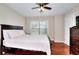 Comfortable bedroom featuring a large window and wood flooring at 2458 Brook Park Trl, Snellville, GA 30078