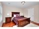 Well-lit bedroom with a wooden bed frame and matching nightstands at 2458 Brook Park Trl, Snellville, GA 30078