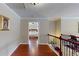 Hallway featuring hardwood floors, decorative wrought iron railing, and view of main bedroom at 2458 Brook Park Trl, Snellville, GA 30078