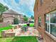 A cozy stone patio featuring an outdoor fireplace and dining set with seating at 2458 Brook Park Trl, Snellville, GA 30078