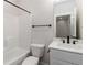 Bright bathroom features a shower-tub combo, matte black accents and a white vanity at 2461 Sycamore Nw Rd, Atlanta, GA 30318
