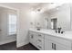 Modern bathroom with dual sinks, vanity, quartz countertop and modern lighting at 2461 Sycamore Nw Rd, Atlanta, GA 30318