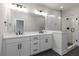 Modern bathroom with dual sinks, vanity, quartz countertop and glass shower at 2461 Sycamore Nw Rd, Atlanta, GA 30318